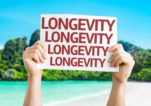 Longevity card in hands — Stock Photo, Image