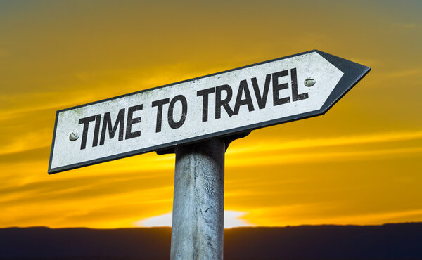 Time to Travel sign with a sunset background