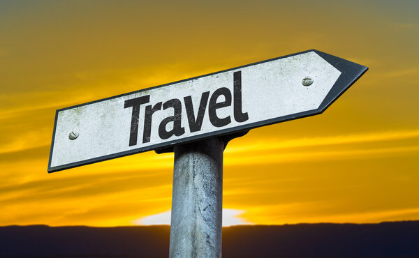 Travel sign with a sunset background