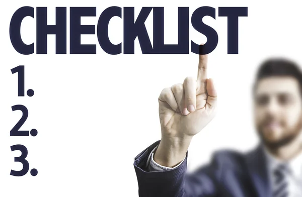 Man pointing the text: Checklist — Stock Photo, Image