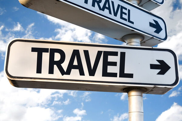 Travel direction sign on sky background