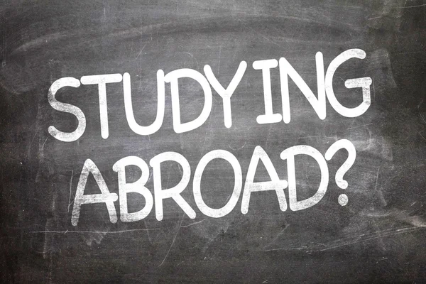 Studying Abroad  on a chalkboard — Stock Photo, Image