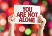 You Are Not Alone placard