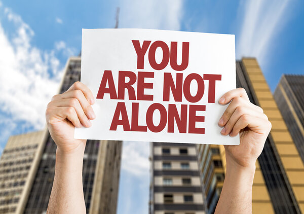 You Are Not Alone placard