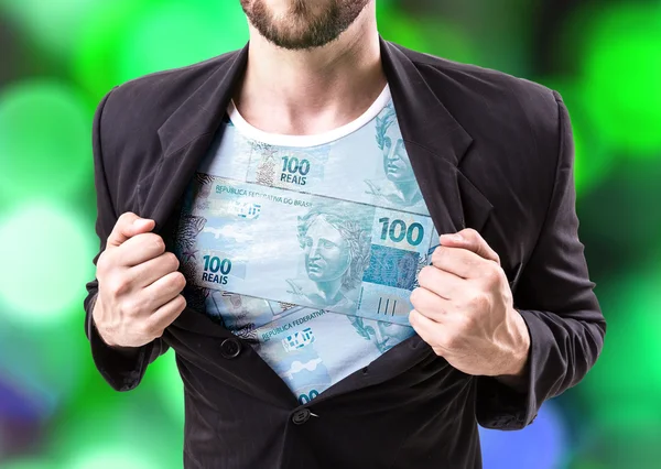 Businessman stretching suit with Brazilian money — Stock Photo, Image