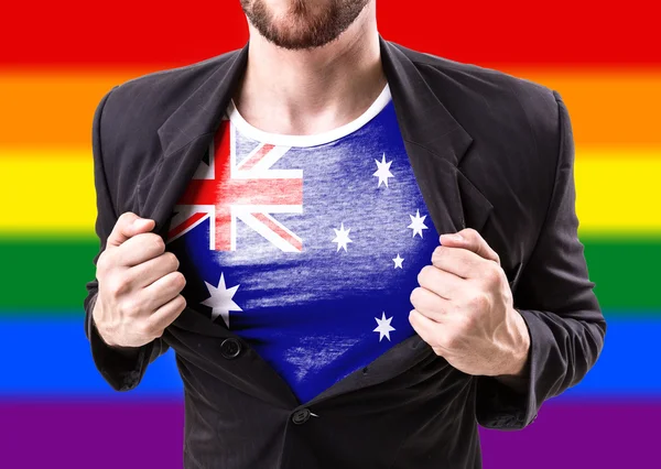 Geschäftsmann streckt Anzug mit australischer Flagge — Stockfoto