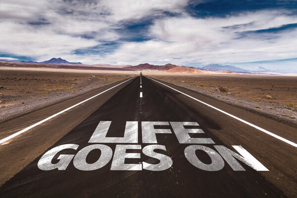 Life Goes On written on road