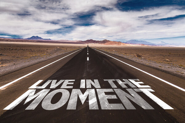 Live in the Moment written on road