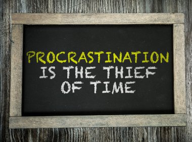 Procrastination is the Thief of Time on chalkboard clipart