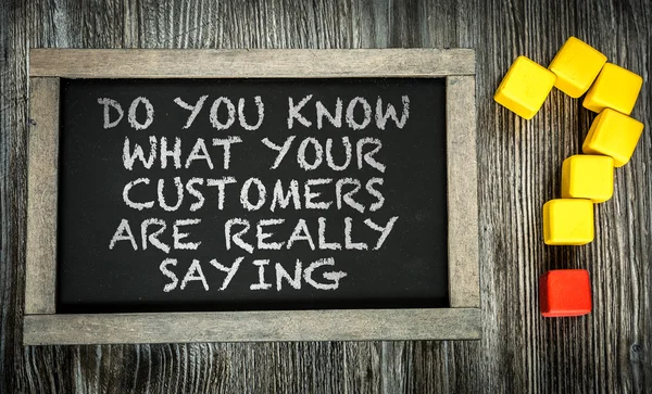 What Customers Are Really Saying? on chalkboard — Stock Photo, Image