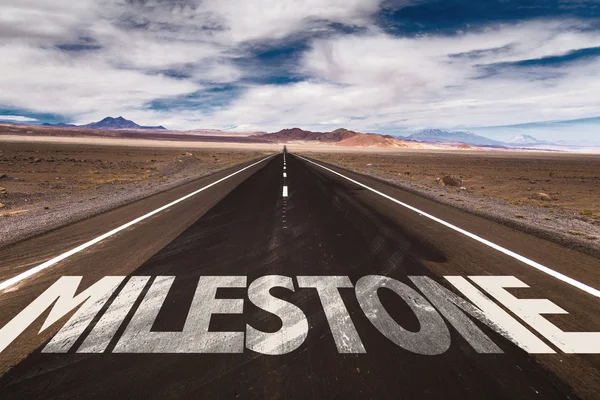 Milestone written on road — Stock Photo, Image