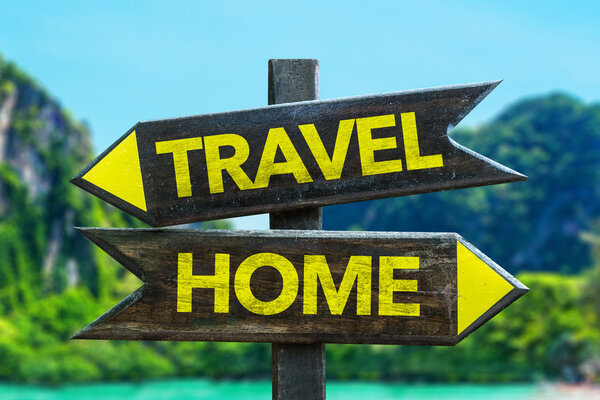 Travel - Home signpost in a beach background
