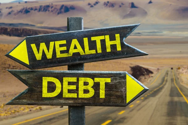 Wealth - Debt signpost — Stock Photo, Image