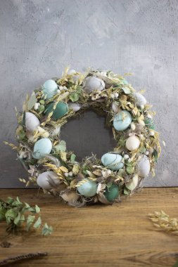 Ahşap arkaplanda yeşil renklerde paskalya çelengi bileşimi