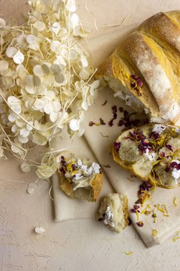 bej arkaplanda beyaz ekmek ve çiçekler