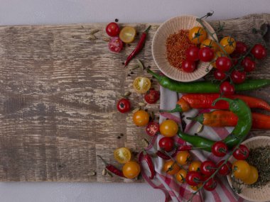 Ahşap tahta, bir tabak domates çorbası ve sebze manzaralı.