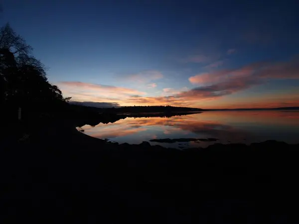 sunrise reflection over water - Lysaker