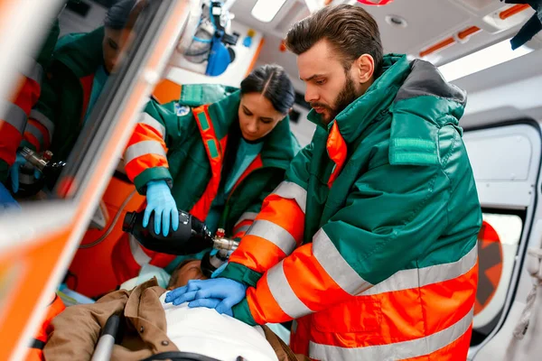 Two Paramedics Resuscitating Senior Lying Gurney Ambulance Performing Chest Compressions — Stock Photo, Image