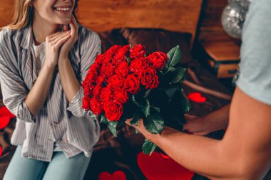 Sevgililer Günü 'nü kutluyoruz. Kırpılmış erkek görüntüsü bir kadına kırmızı güller verir..