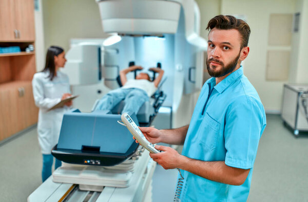 A young woman is undergoing radiation therapy for cancer under the supervision of doctors in a modern cancer hospital. Cancer therapy, advanced medical linear accelerator.