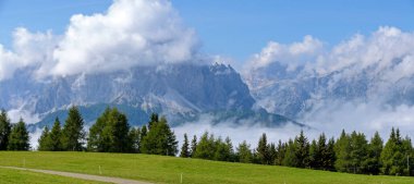 view from the mountain Helm to the socalled Elferkofel part of the Sexten Dolomites, partly in clouds, Italy clipart