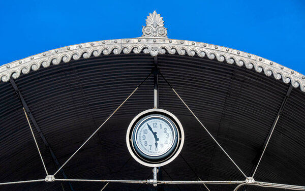  Clock on the artfully designed roof of the ferry station to Paradiso on the southern shore of Lake Lugano in the canton of Ticino, Switzerland