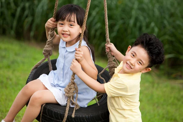 Cheerful Chinese Children Playing Swing — Stock Photo, Image