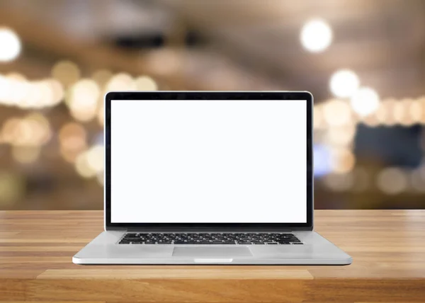 Laptop with blank screen on table. interior background, blurred