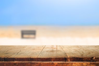 Empty wooden table and blurred beach background clipart