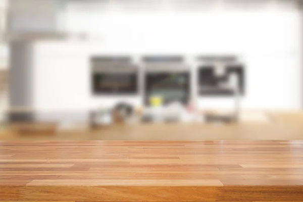 Empty wooden table and blurred kitchen background