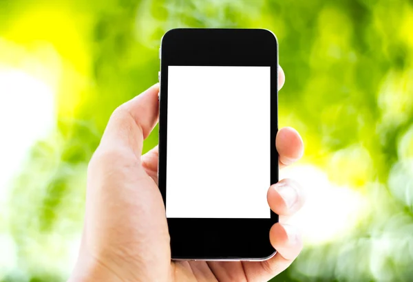 Hand holding phone with nature background — Stock Photo, Image