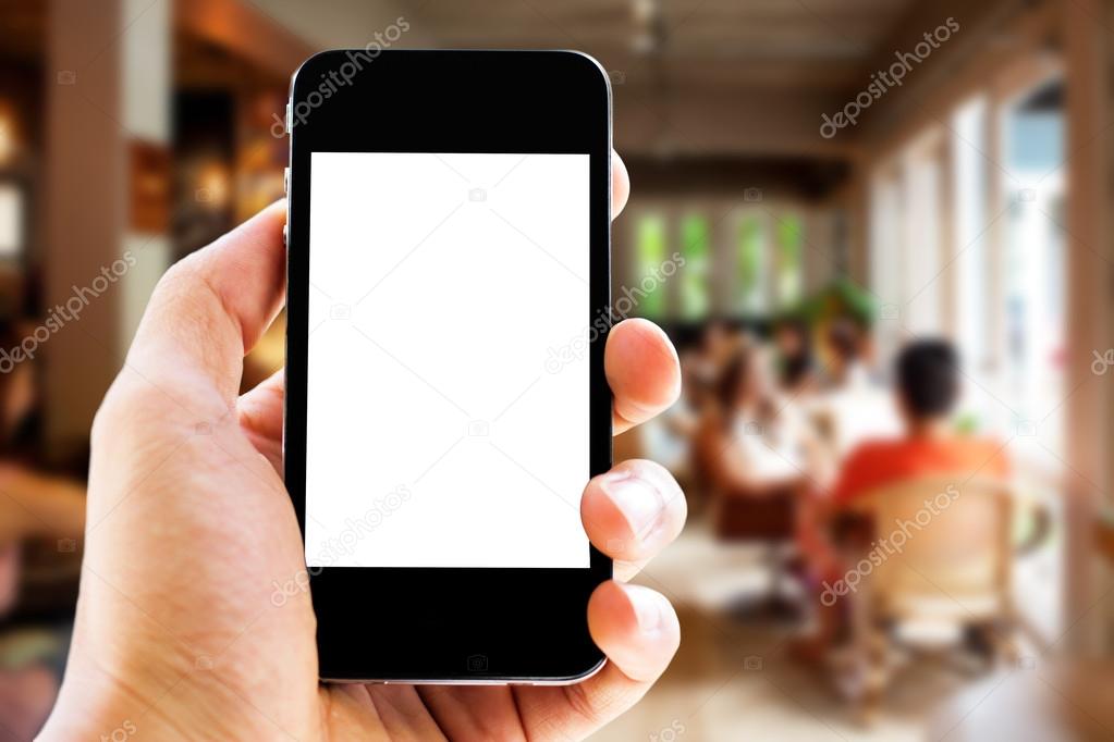 hand holding phone with blurred cafe  background