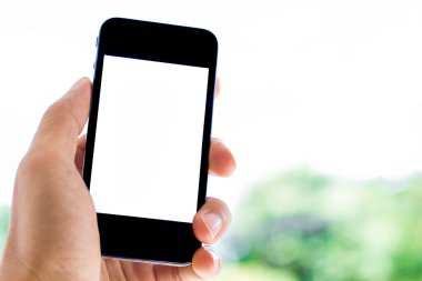 yakın çekim el bulanık doğa arka plan ile akıllı telefon tutarak