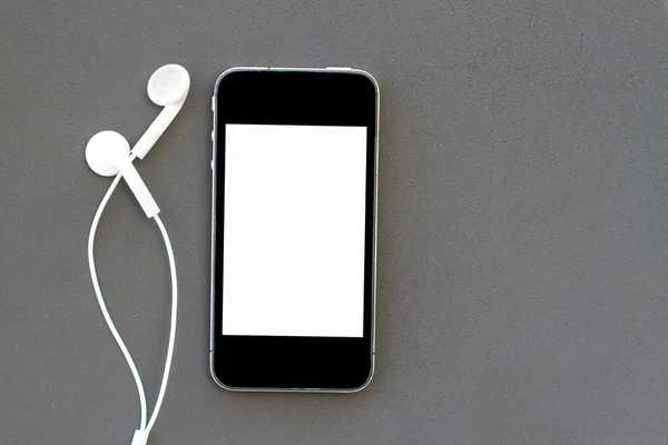 Closeup of black smartphone with white screen with headphones. — Stock Photo, Image
