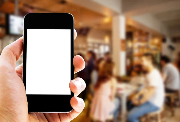 el telefon bulanık café arka plan ile tutarak