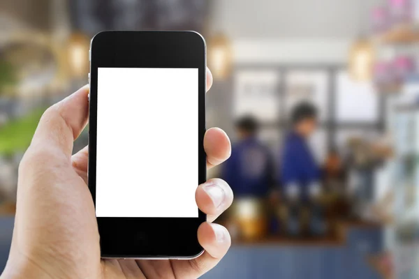 Mano sosteniendo el teléfono en café café fondo — Foto de Stock