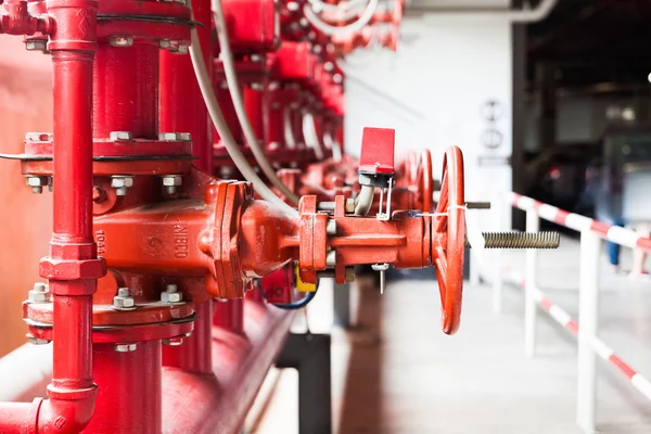 Una fila de fuego de color rojo que combate el sistema de tuberías de suministro de agua — Foto de Stock