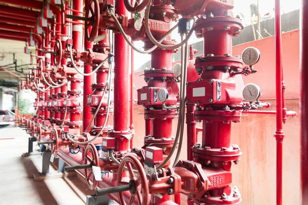 A row of red color fire fighting water supply pipeline system — Stock Image A row of red color fire fighting water supply pipeline system Royalty Free Stock Photos