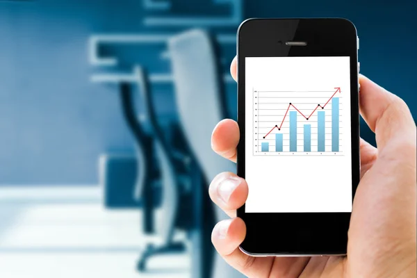 Closeup hand holding mobile phone with analyzing graph — Stock Photo, Image