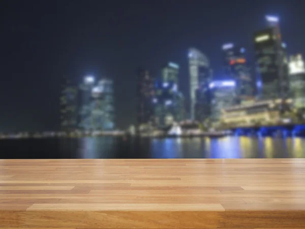 Empty wooden table and cityscape background — Stock Photo, Image