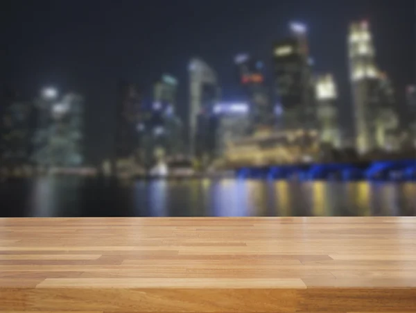 Empty wooden table and cityscape background — Stock Photo, Image