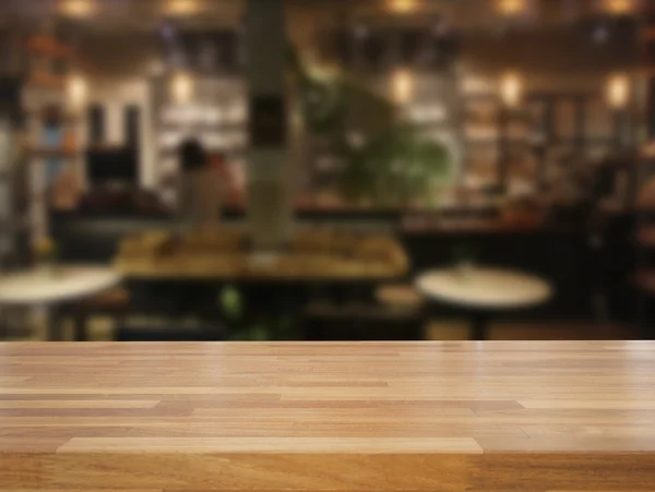 Mpty wooden table and blurred cafe background — Stock Photo, Image