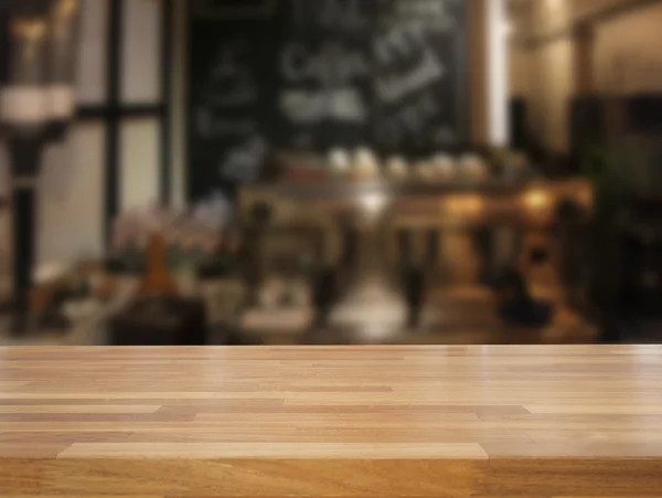 Mpty wooden table and blurred cafe background — Stock Photo, Image