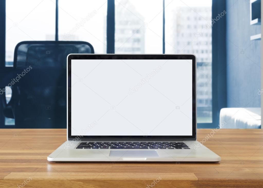 Laptop on table, on office background