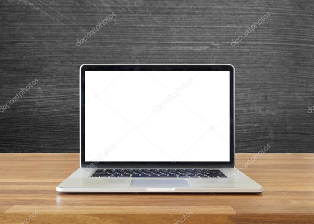 Laptop on table, on  blackboard background