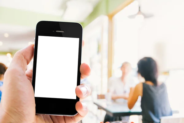 Mano celebración de teléfono inteligente borrosa fondo de personas que hablan en —  Fotos de Stock