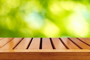 Boş ahşap masa ve yeşil doğal kaynak bokeh adam bulanıklığı