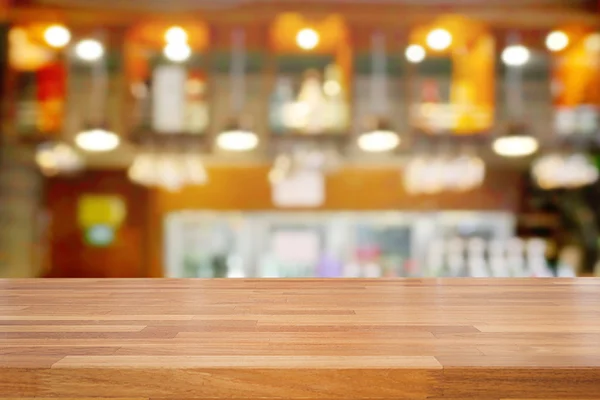 Meja kayu kosong dan latar belakang kafe yang kabur — Stok Foto
