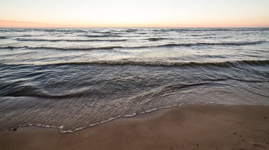 bulutlar ve ıssız dune doğru dalgalar ile sonbaharda Baltık beach