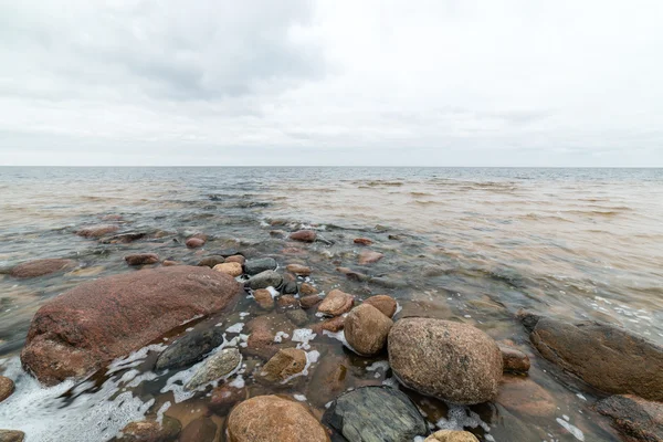 Felsiger Herbststrand mit Wellen, die auf die Felsen krachen — Stockfoto